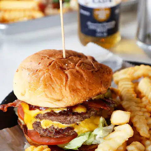 Bacon cheeseburger served with crinkle-cut fries